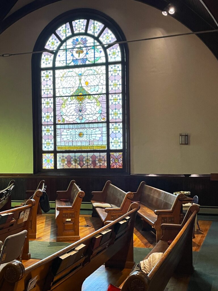 A stained glass window with artistic designs. It's very Victorian, and very beautiful.