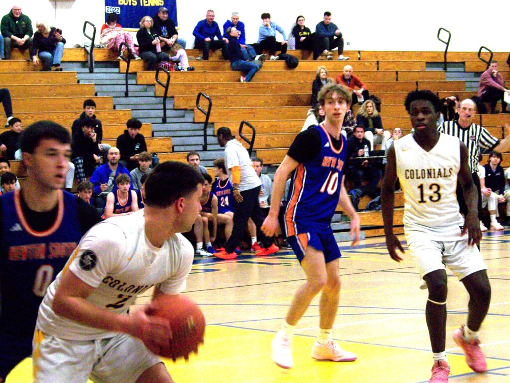 A boy is ready to pass the ball to another AB player.