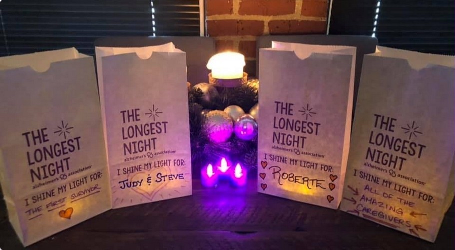 Four paper bags lit up from the inside that are labeled as The Longest Night. I shine my light for.... * The first survivor (of Alzheimer's) * Judy & Steve * Roberte * All of the amazing caregivers