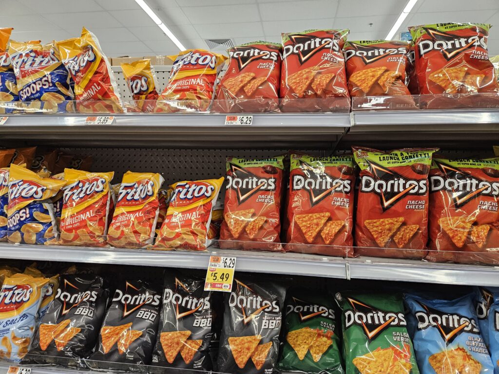An almost full display of Fritos and Doritos.