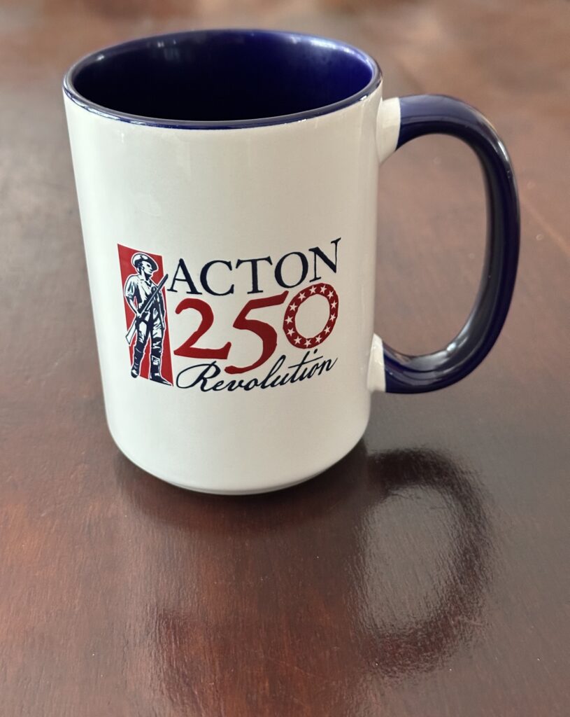 An Acton 250 coffee mug, that includes a picture of a Minuteman.