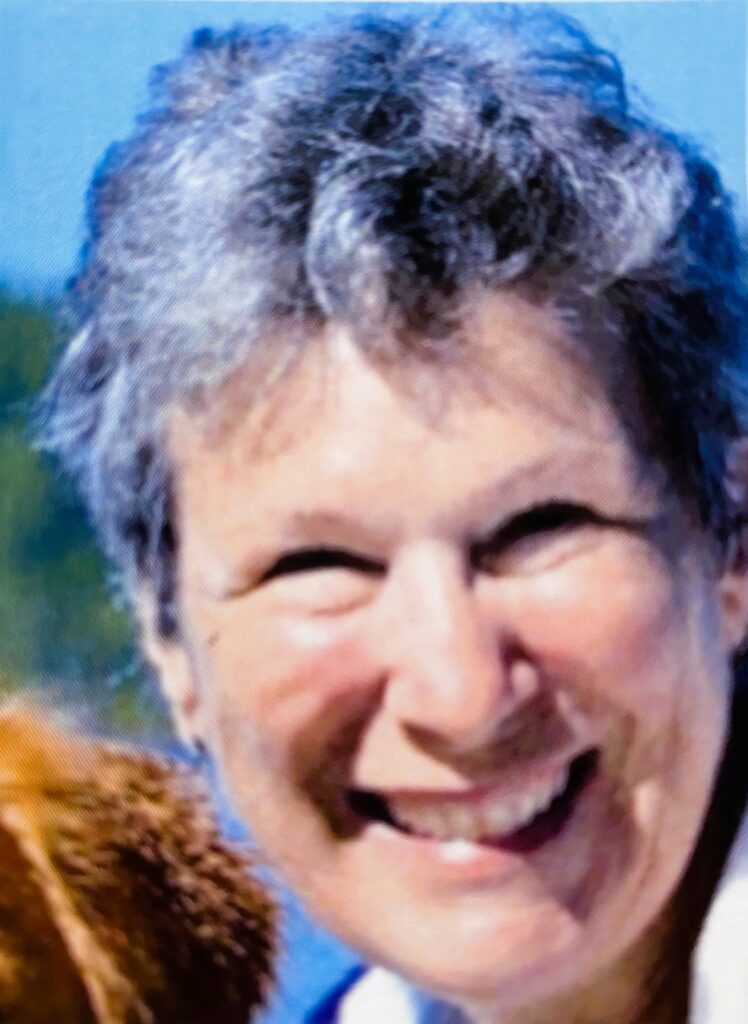 A smiling grey-haired woman.