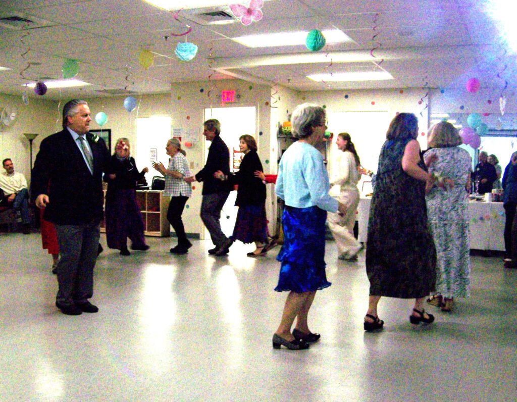 People dancing in a conga line.