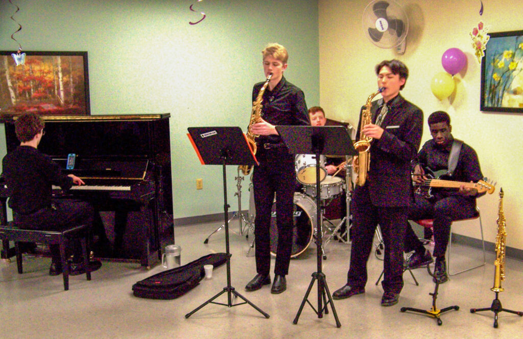 Five high-school musicians, dressed in black.