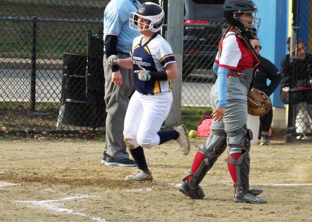 A Revs player runs into home. The Waltham catcher is waiting for a ball.