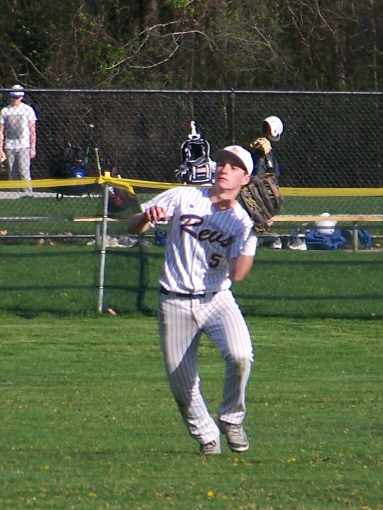 A Revs player has his mitt up ready to catch a ball.