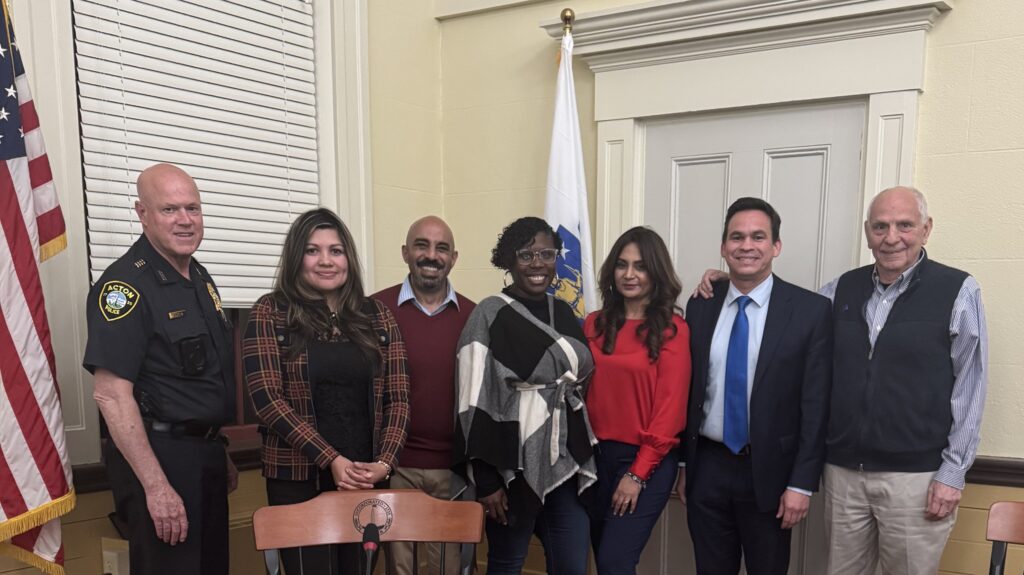 A group of people stand at Town Hall.