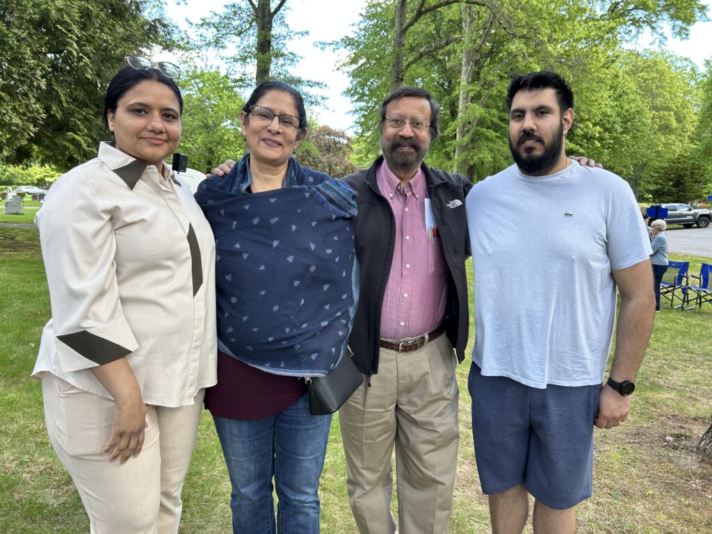 Four members of a family; a youngish woman, older woman, older man, and youngish man.