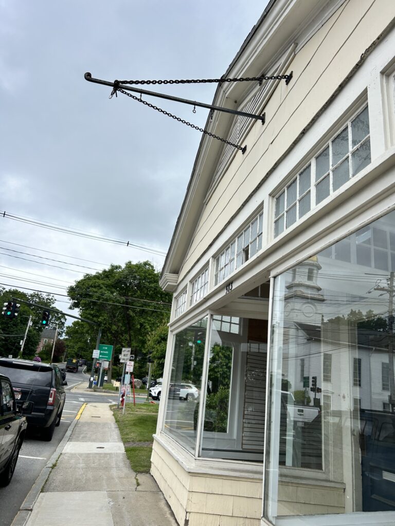 A beige building. The post where the sign used to be is now empty.