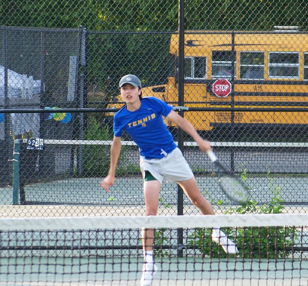 An AB plaer follows through on a stroke.