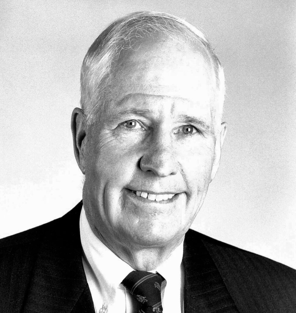 Blackadand white headshot of smiling older man.