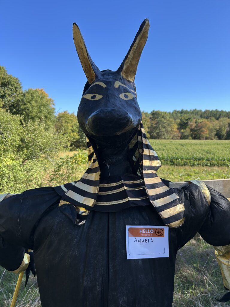 A black and gold representation of the god Anubis.
