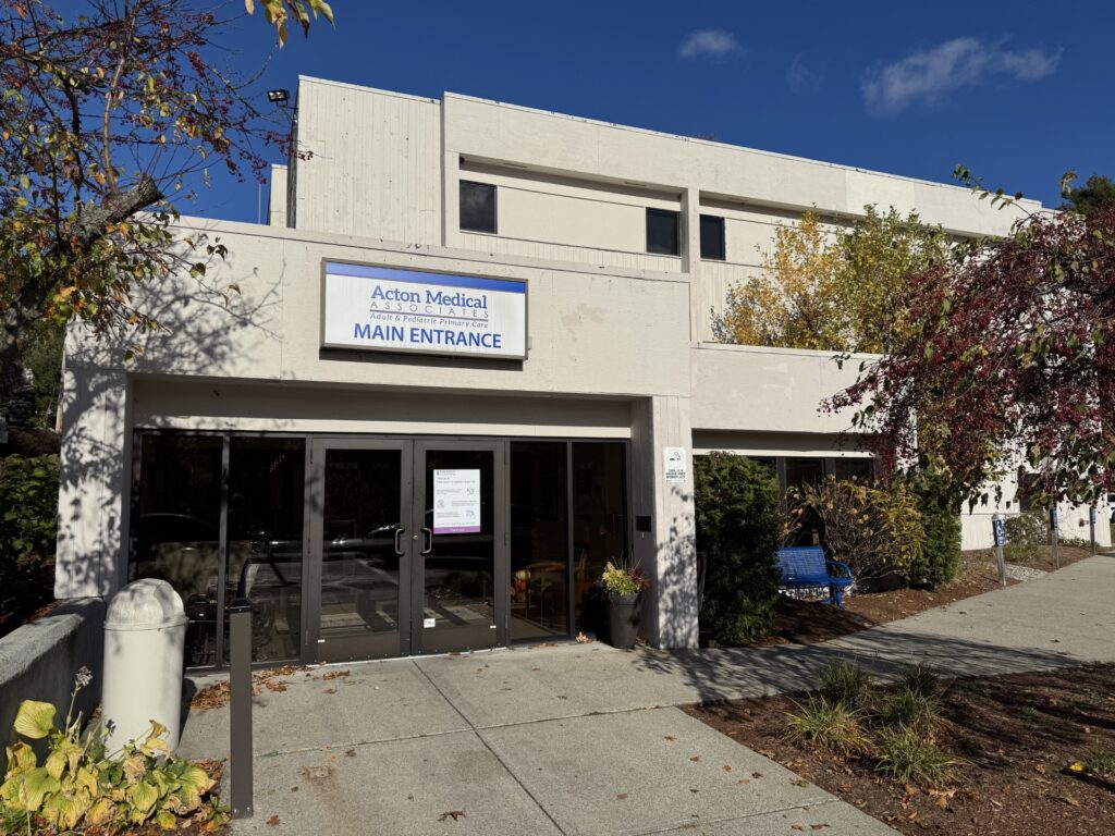The entrance to a concrete building with the Acton Medical sign.