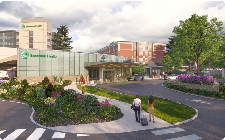 A drawing of a new glass fronted building that says "Emerson Health." The drawing includes lovely greenery in the front and an ambulance bay.