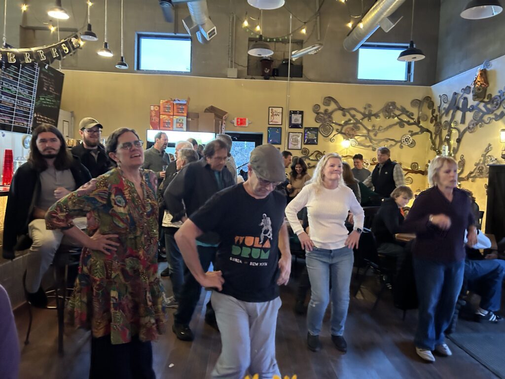 A group of people line dancing (more or less)
