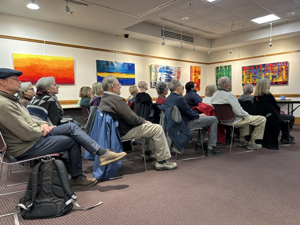 Every chair is filled in the Acton Memorial Library meeting room.