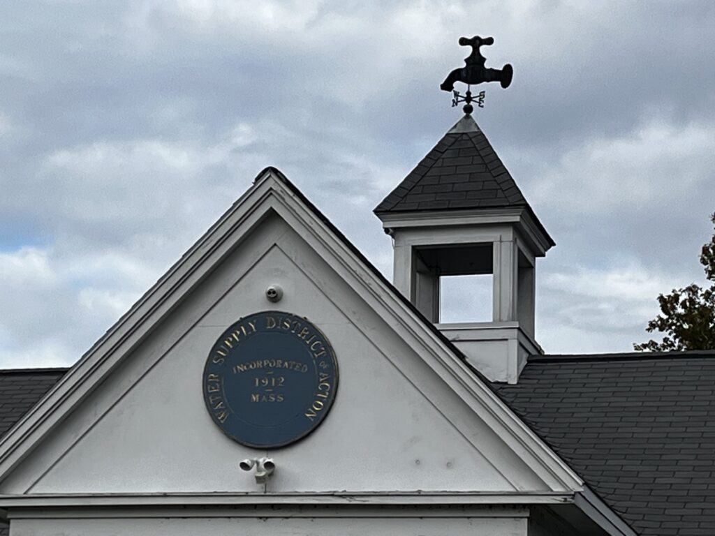 The top of the Acton Water Supply building with its faucet shaped weathervane.
