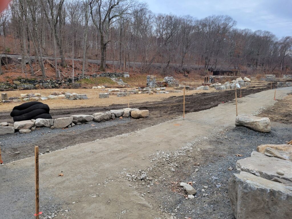 Gravel paths outlined with sticks. Boulders along the path outline (that is, echo), buildings that no longer exist.